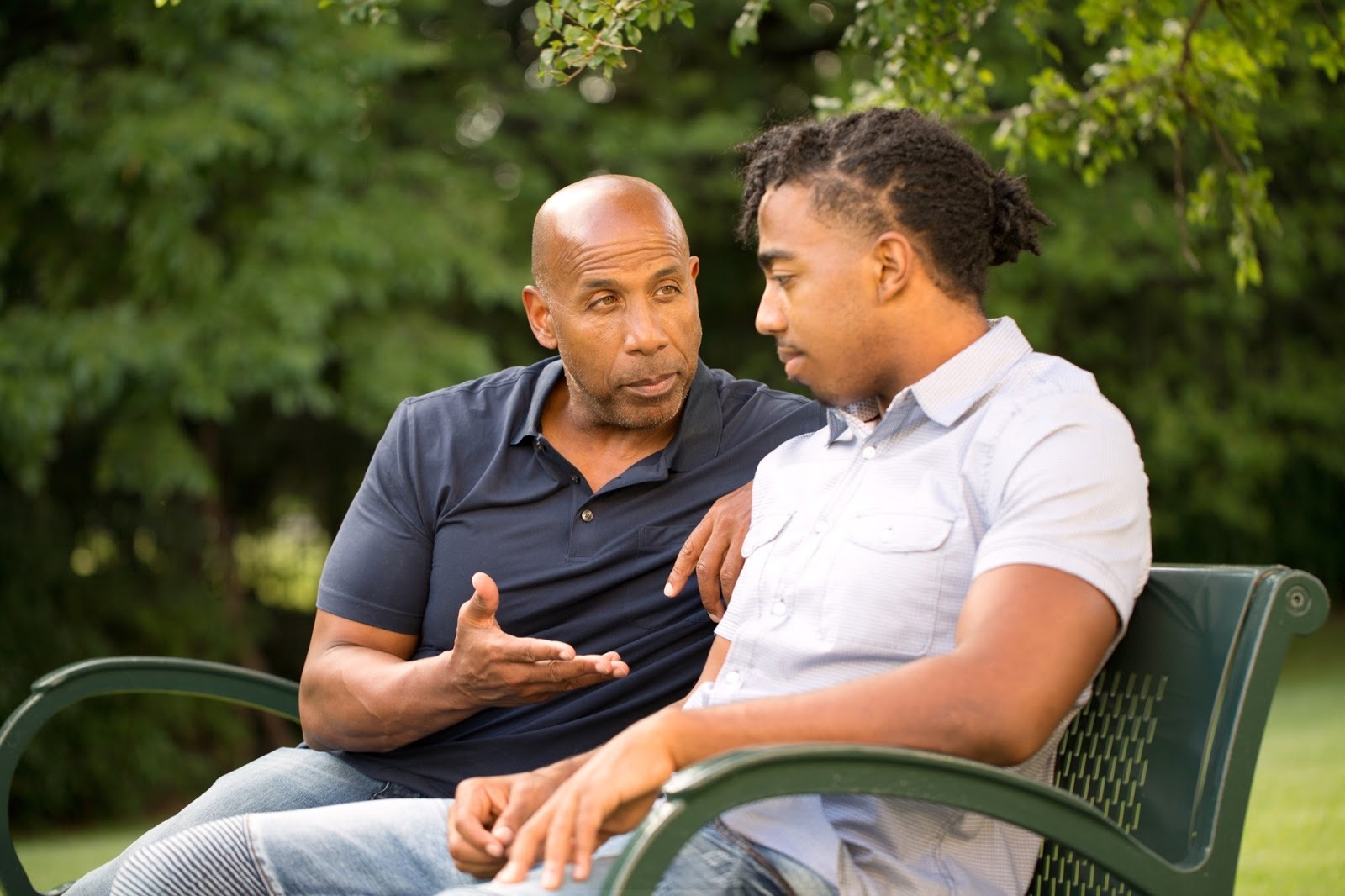 Two men talking on a bench