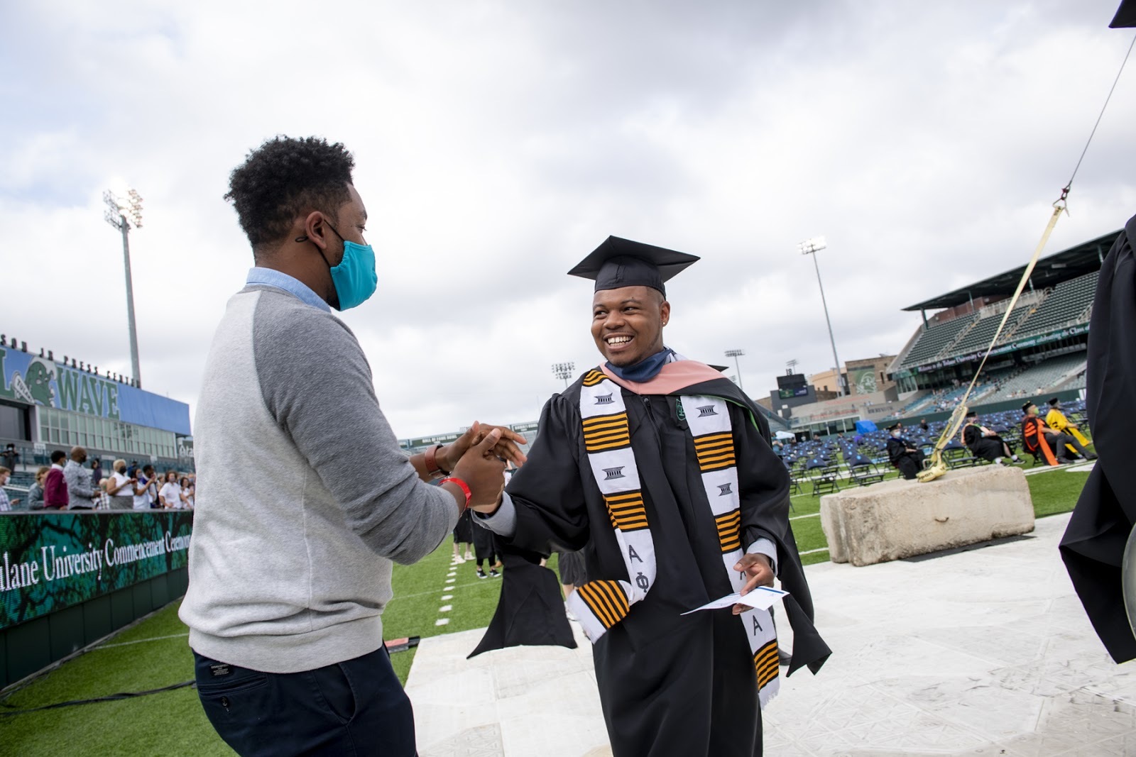 Alpha Phi Alpha member graduates from Tulane congratulate each other