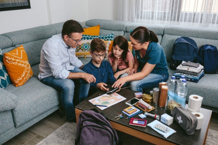 A family assembles an emergency kit.