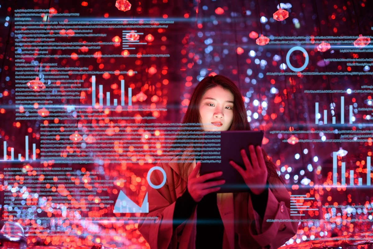 A young woman holds a tablet against a background of graphic charts and text.