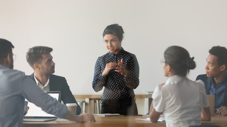 A woman leads a team meeting.