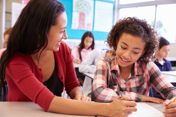 Smiling teacher with student.