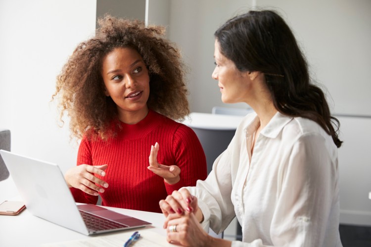 A new teacher confers with their mentor.