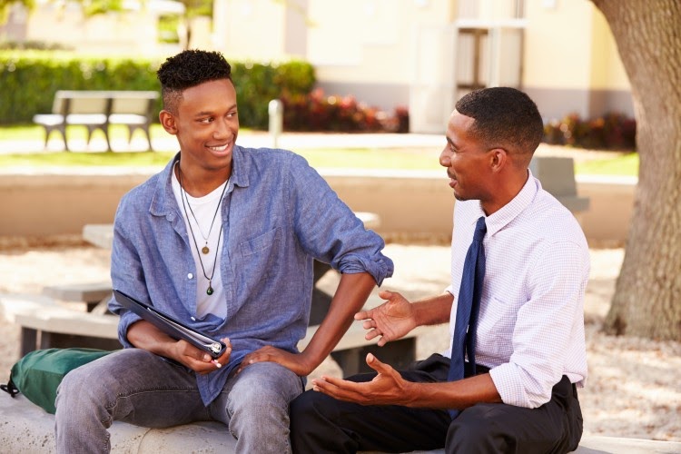 A high school student meets with a mentor.