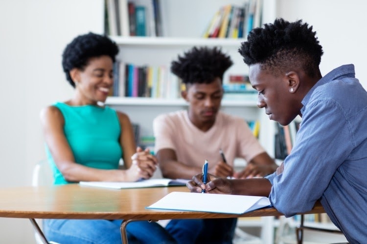 A student works at a desk.