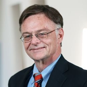 A professional image of Gregory Jonas