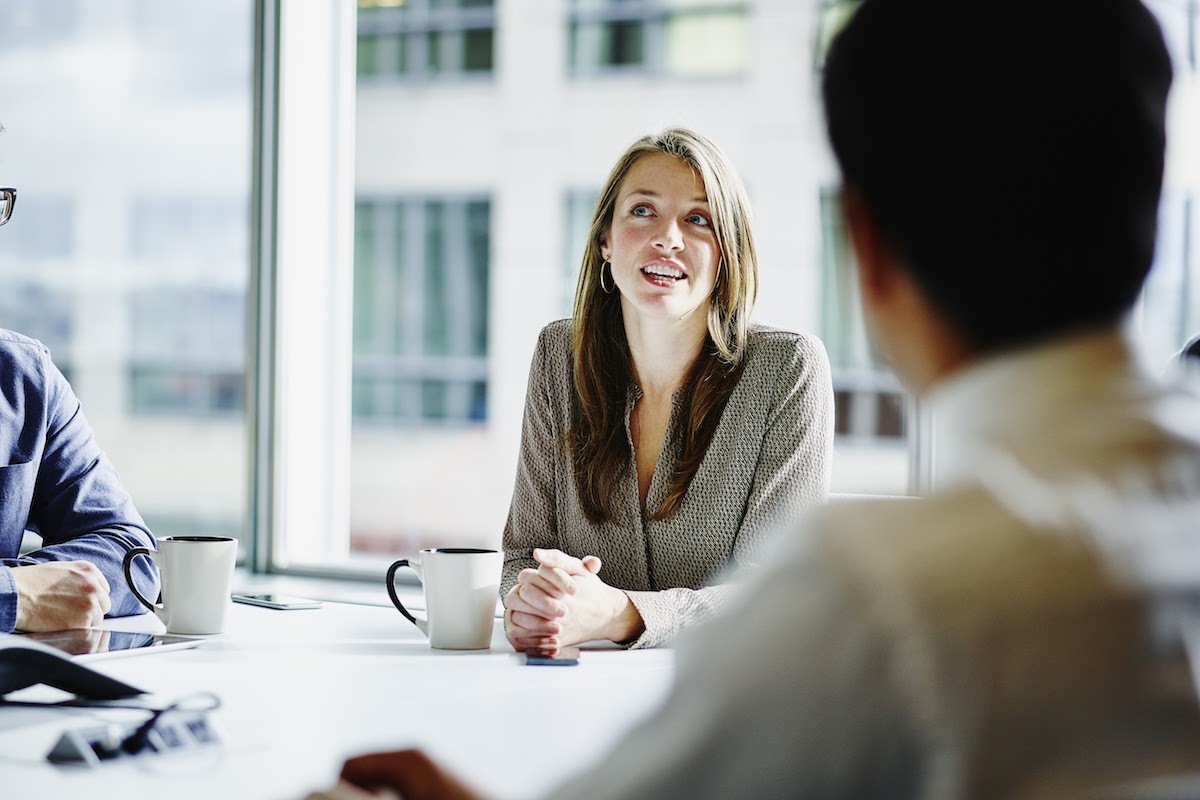 A female business executive leading a discussion in an office.